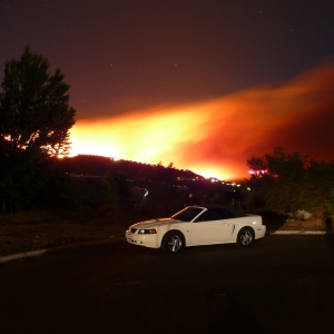 Mustang in forground with Mt Miguel burning